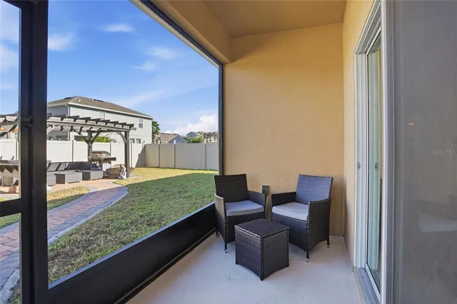 a view of a porch with furniture and yard