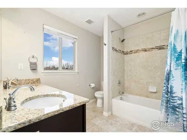 a view of an empty room with furniture and wooden floor