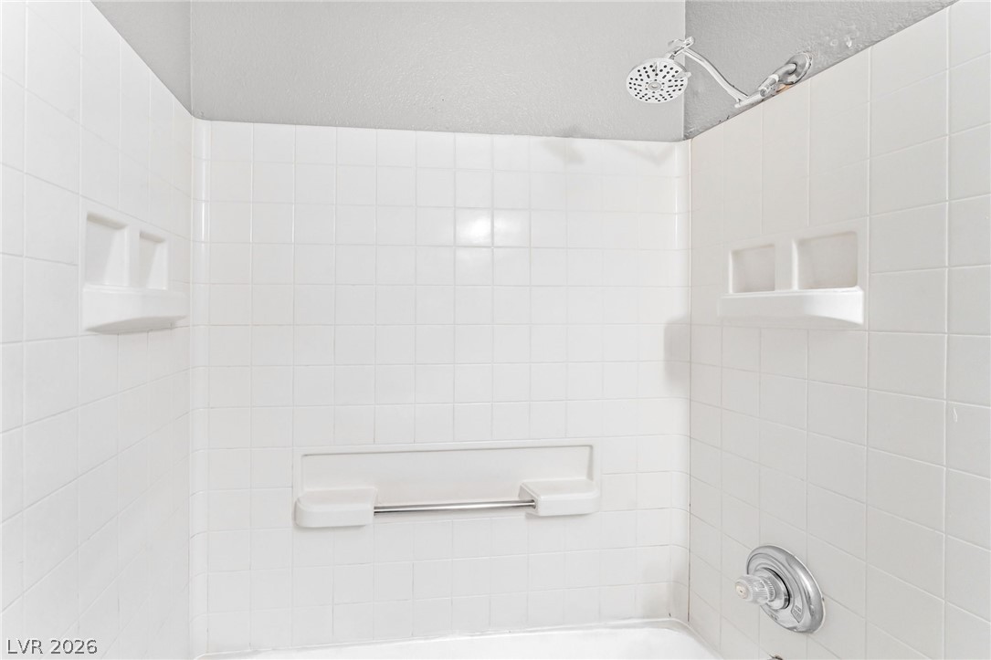 3318 North Decatur Boulevard, Unit 2152 Las Vegas, NV 89130 - Photo 20 of 58 White subway tiles encompass this functional shower and bathtub combination.
