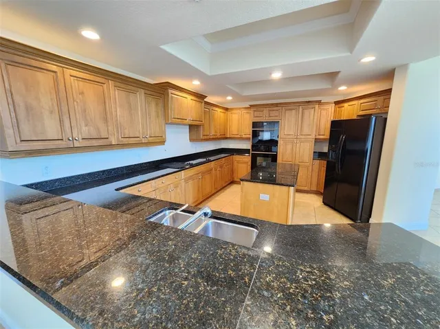 a view of a kitchen with a sink and a refrigerator