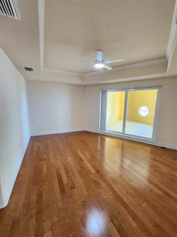 a view of empty room with wooden floor