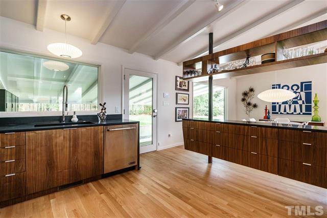 3322 Ocotea Street Raleigh, NC 27607 - Photo 9 of 31 a kitchen with stainless steel appliances granite countertop a large counter top a stove and a wooden floors
