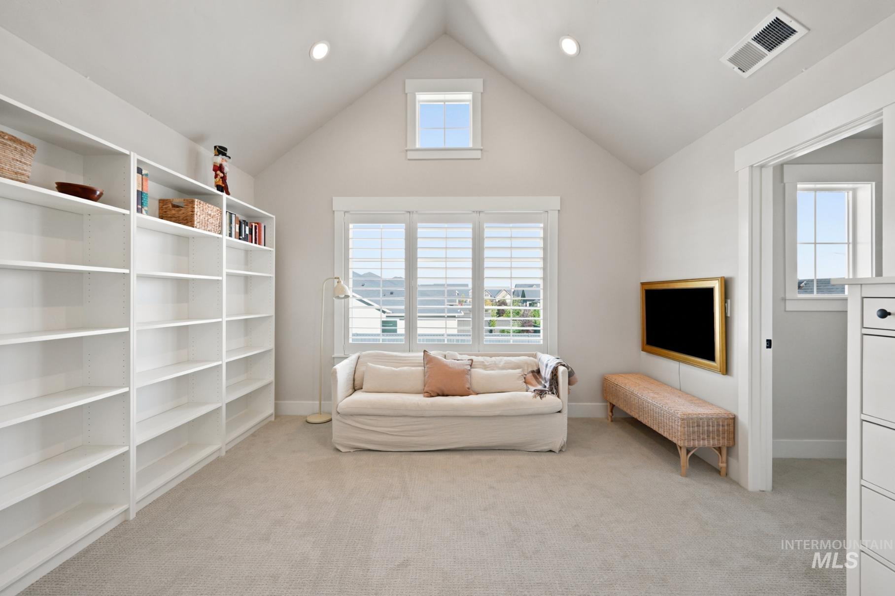 6933 South Zenith Avenue Meridian, ID 83642 - Photo 19 of 34 Attic space featuring a vaulted ceiling and an abundance of natural light from multiple windows
