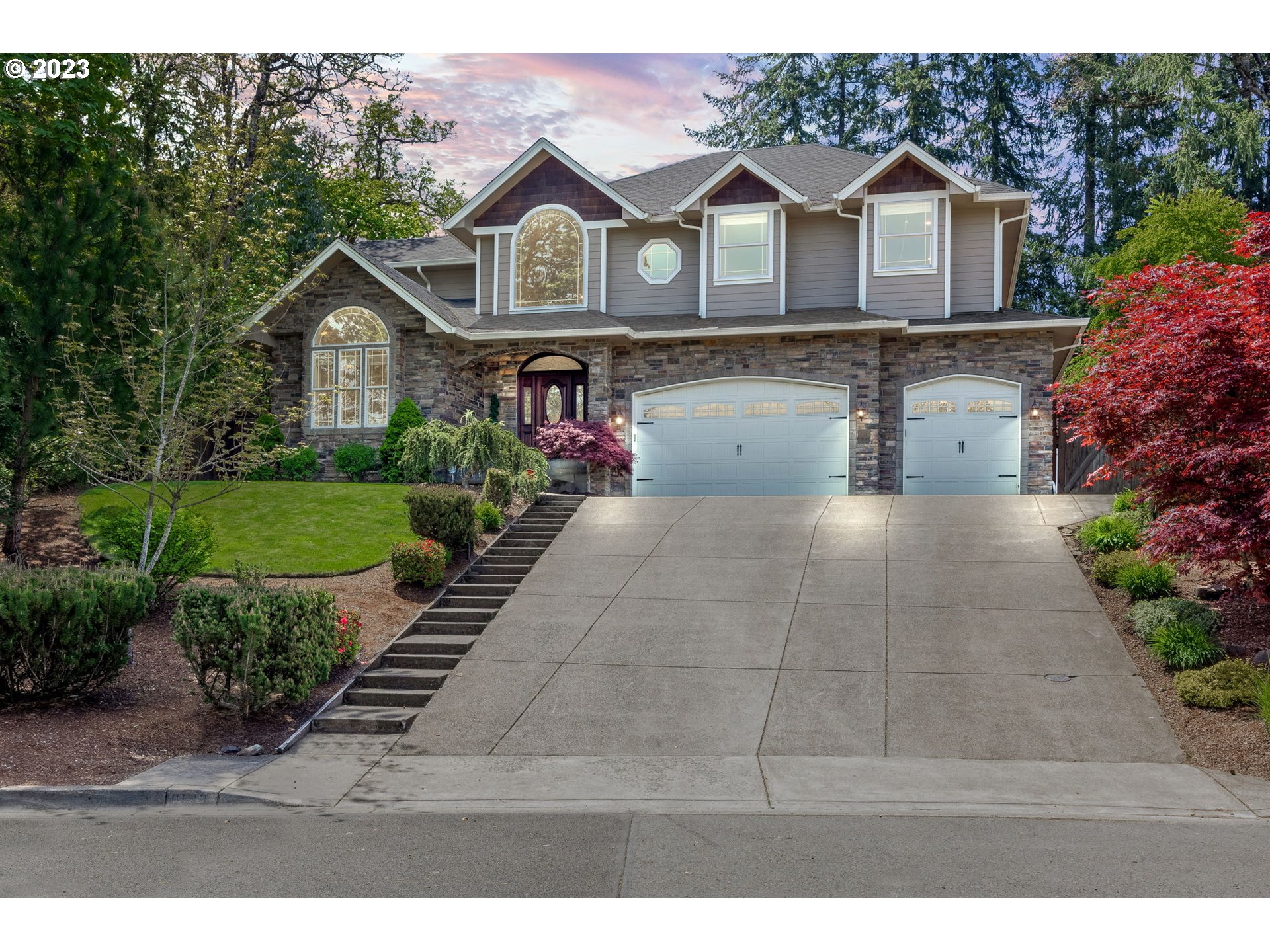 a front view of a house with a yard and garage