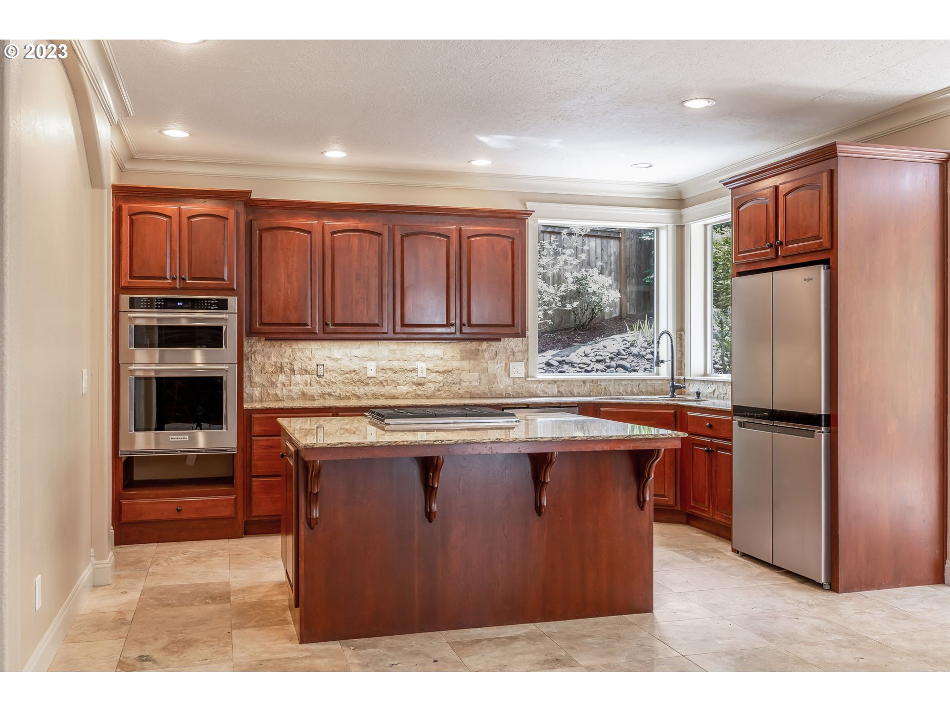6143 Forest Ridge Drive Springfield, OR 97478 - Photo 12 of 48 a kitchen with stainless steel appliances granite countertop a refrigerator a stove and a sink with wooden cabinets