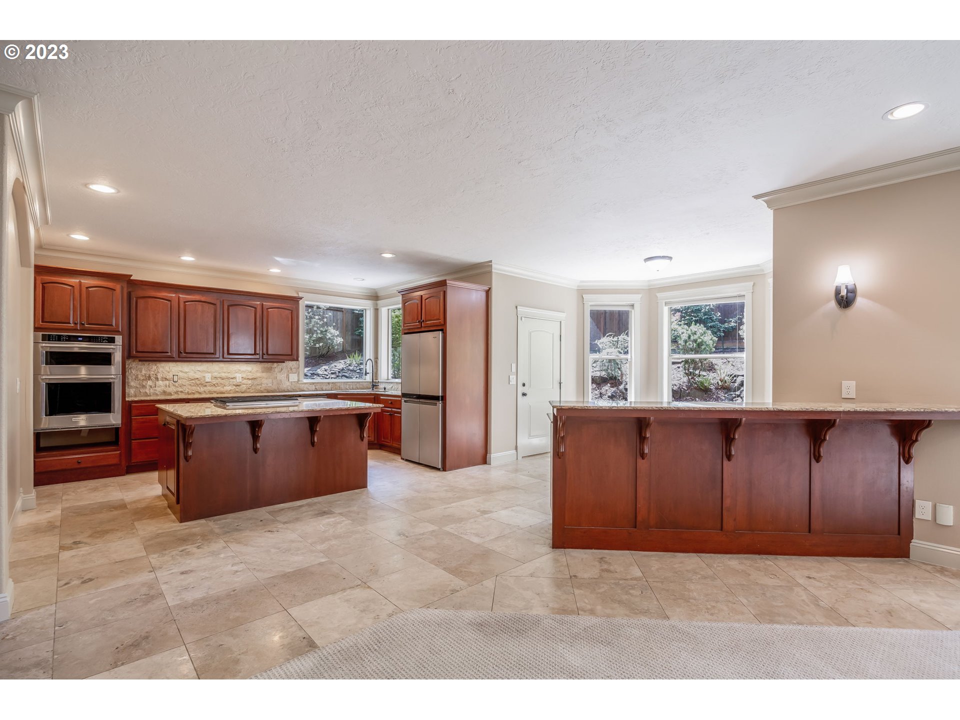 6143 Forest Ridge Drive Springfield, OR 97478 - Photo 13 of 48 a large kitchen with stainless steel appliances kitchen island granite countertop a large counter top and oven