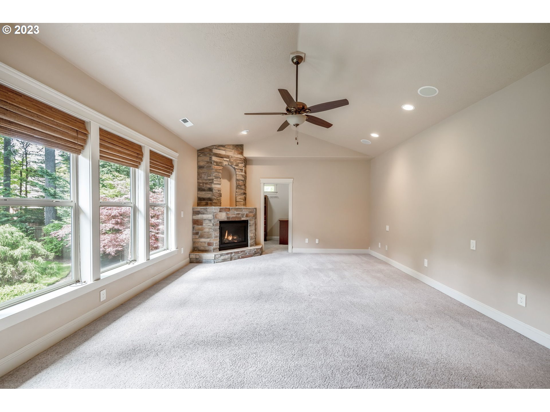 6143 Forest Ridge Drive Springfield, OR 97478 - Photo 18 of 48 a view of an empty room with a fireplace and a window