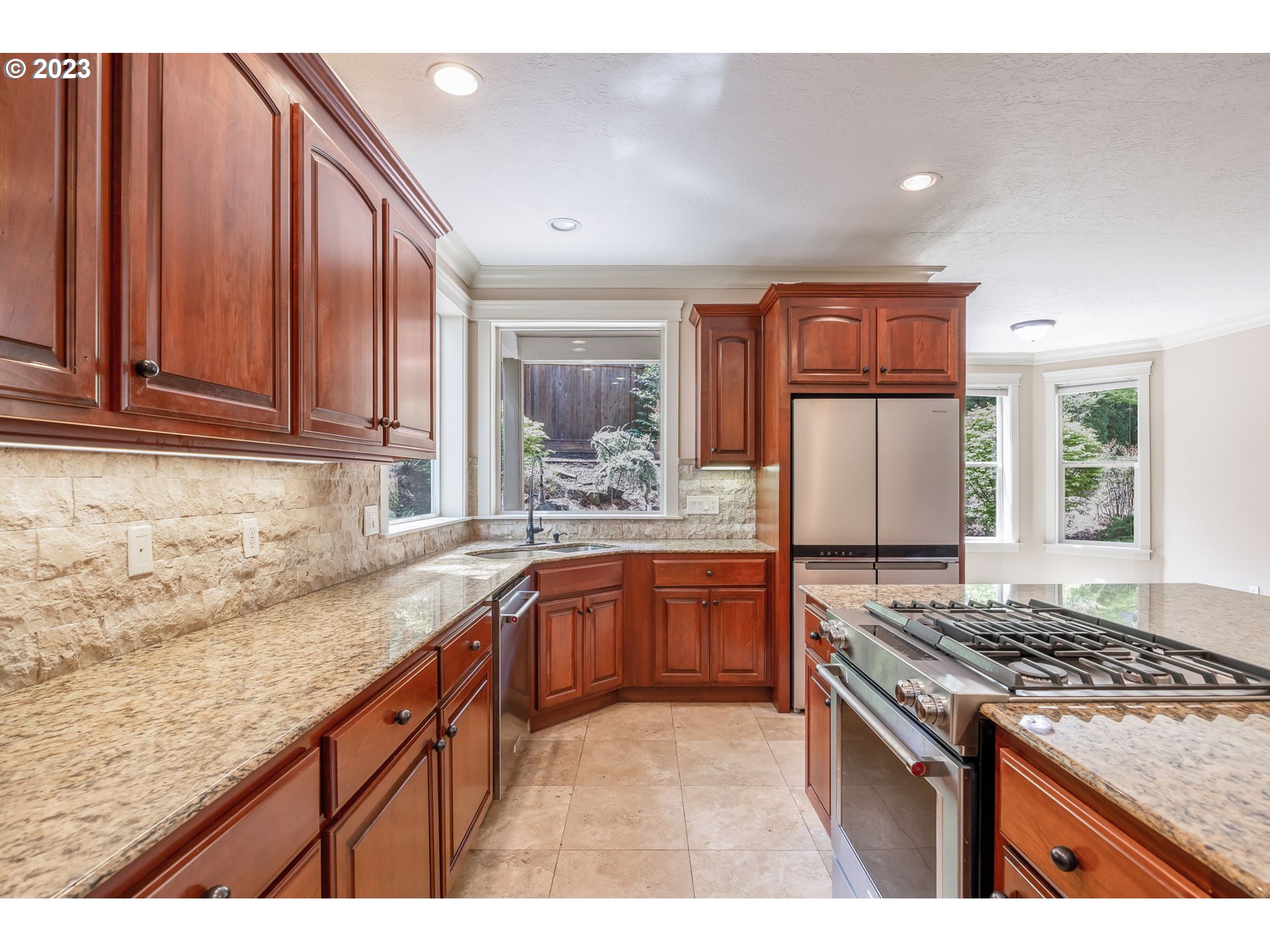 6143 Forest Ridge Drive Springfield, OR 97478 - Photo 10 of 48 a kitchen with granite countertop wooden cabinets and stainless steel appliances