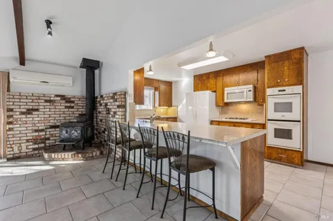 an empty room with wooden floor and window