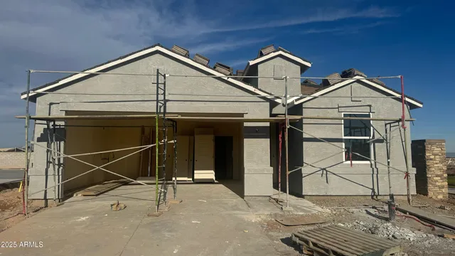 a view of a house with wooden fence
