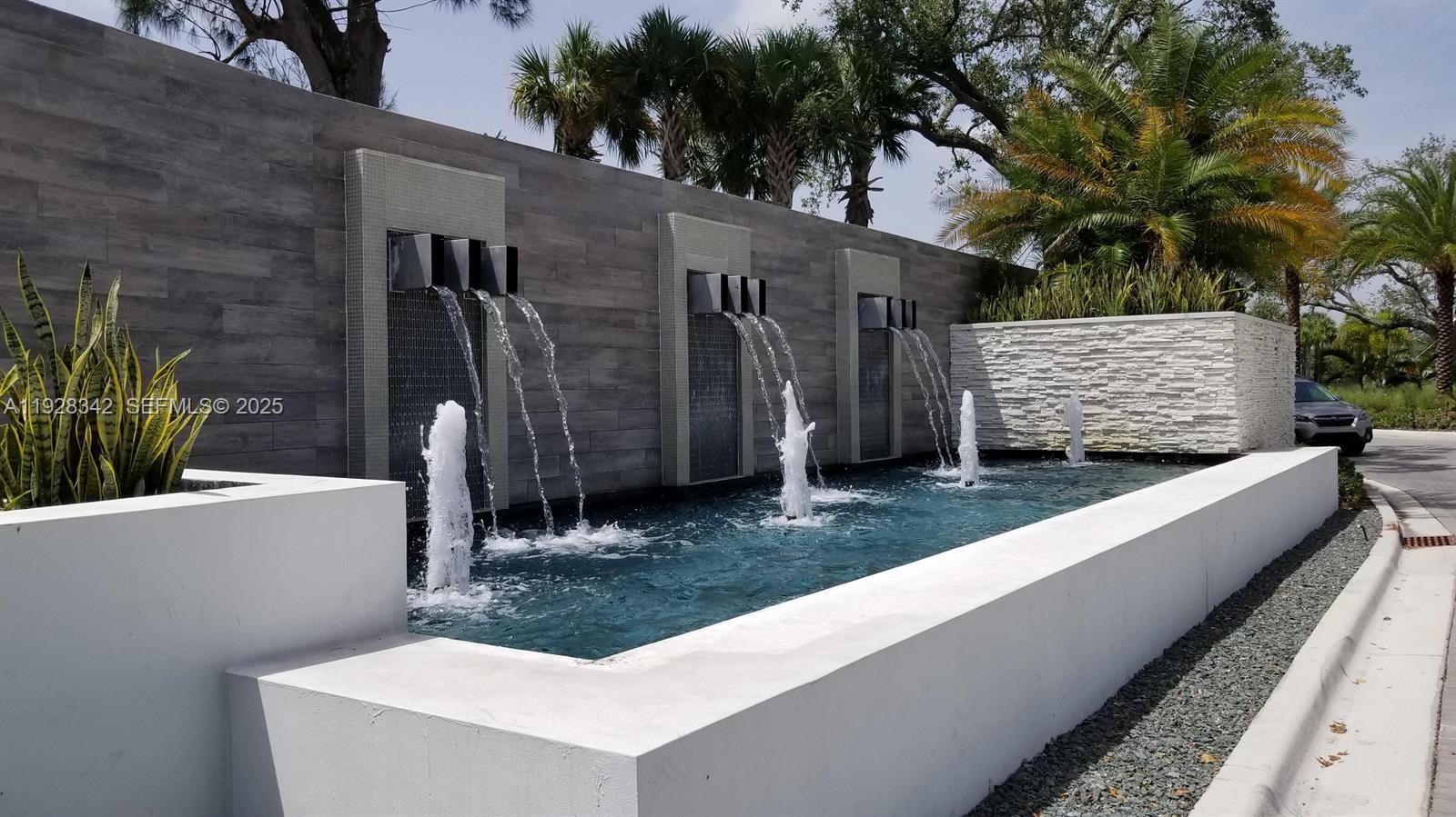 a view of a house with a tub and potted plants