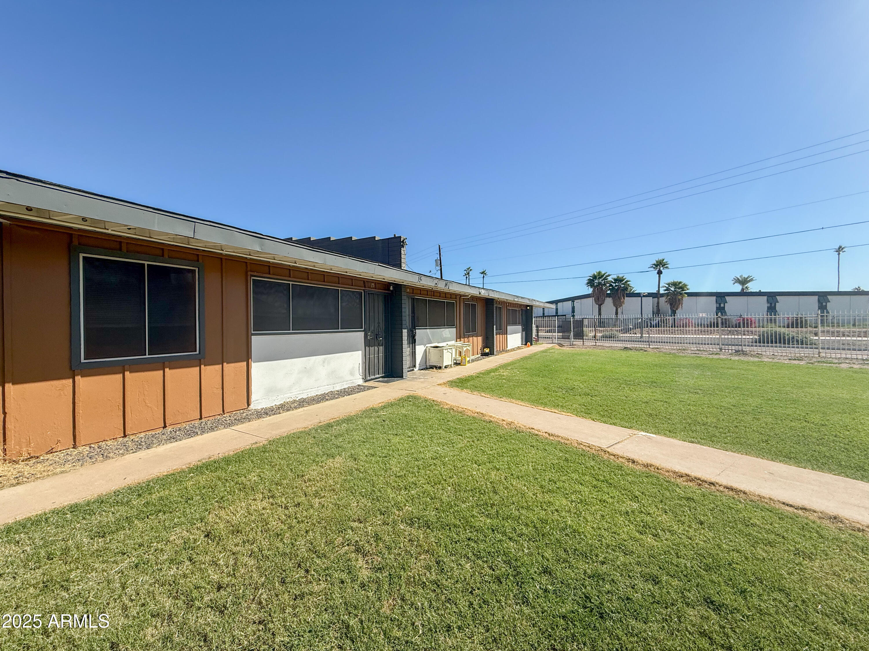 2123 West Devonshire Avenue, Unit 15 Phoenix, AZ 85015 - Photo 1 of 14 a front view of a house with a yard