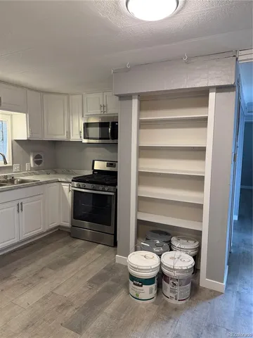 a kitchen with a cabinets and appliances