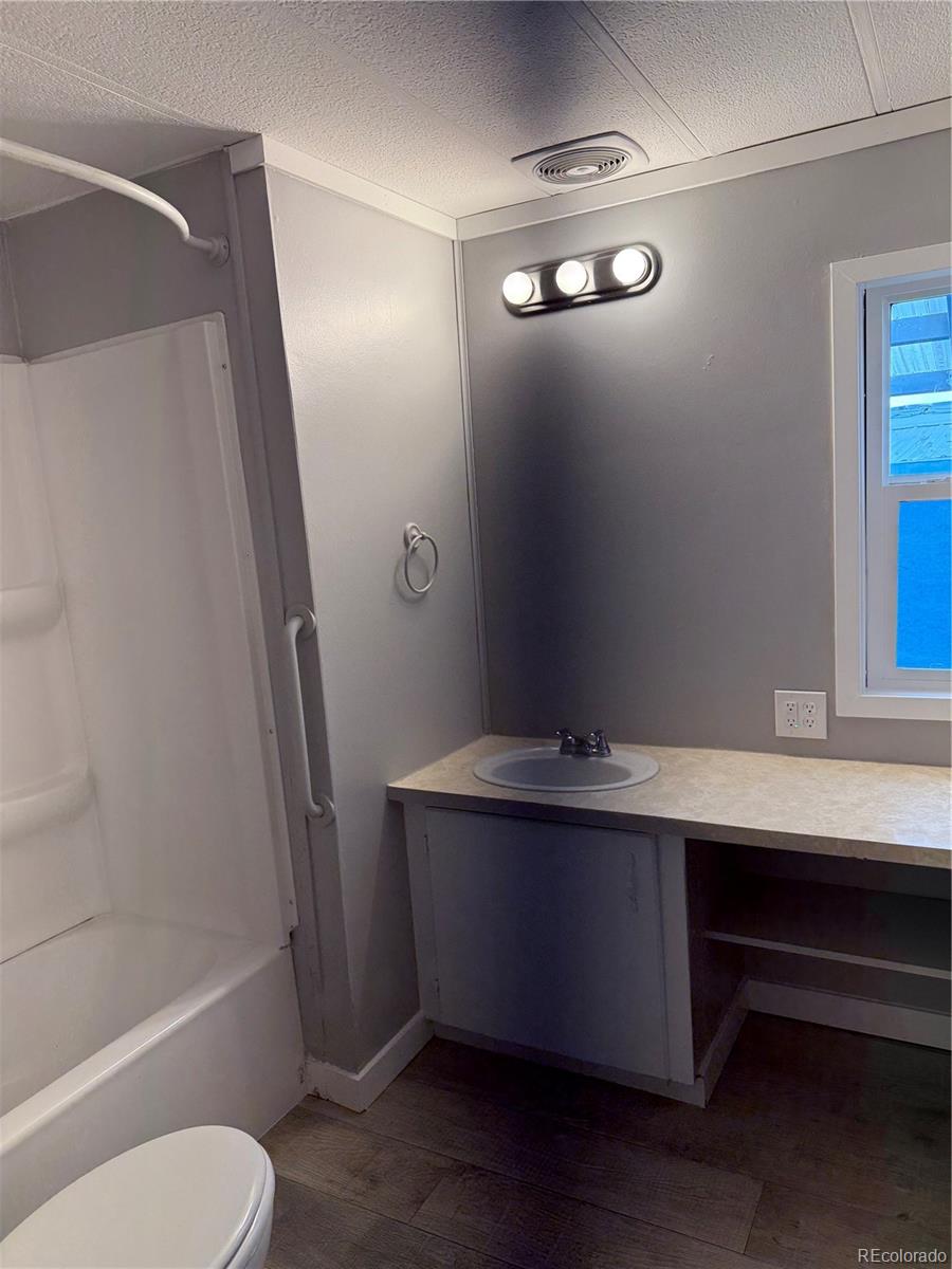 17190 Mt Vernon Road, Unit 176 Golden, CO 80401 - Photo 13 of 39 a bathroom with a sink a toilet a mirror and shower