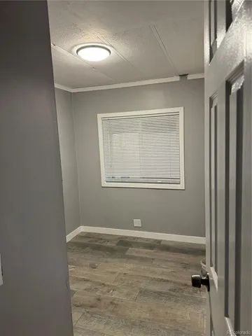 a view of a room with wooden floor and closet