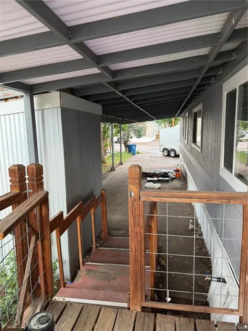a view of outdoor space with wooden floor and windows