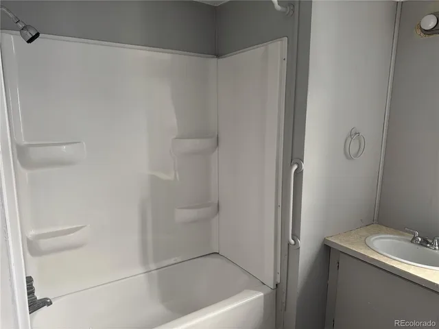 a white toilet sitting next to a bath tub