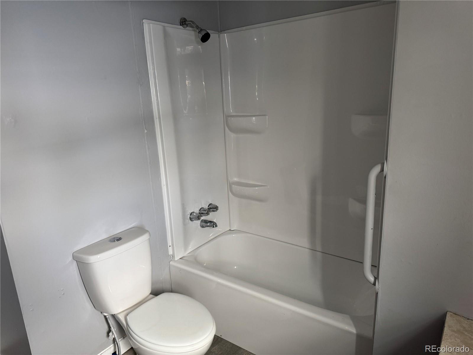 17190 Mt Vernon Road, Unit 176 Golden, CO 80401 - Photo 28 of 39 a white toilet sitting next to a bath tub