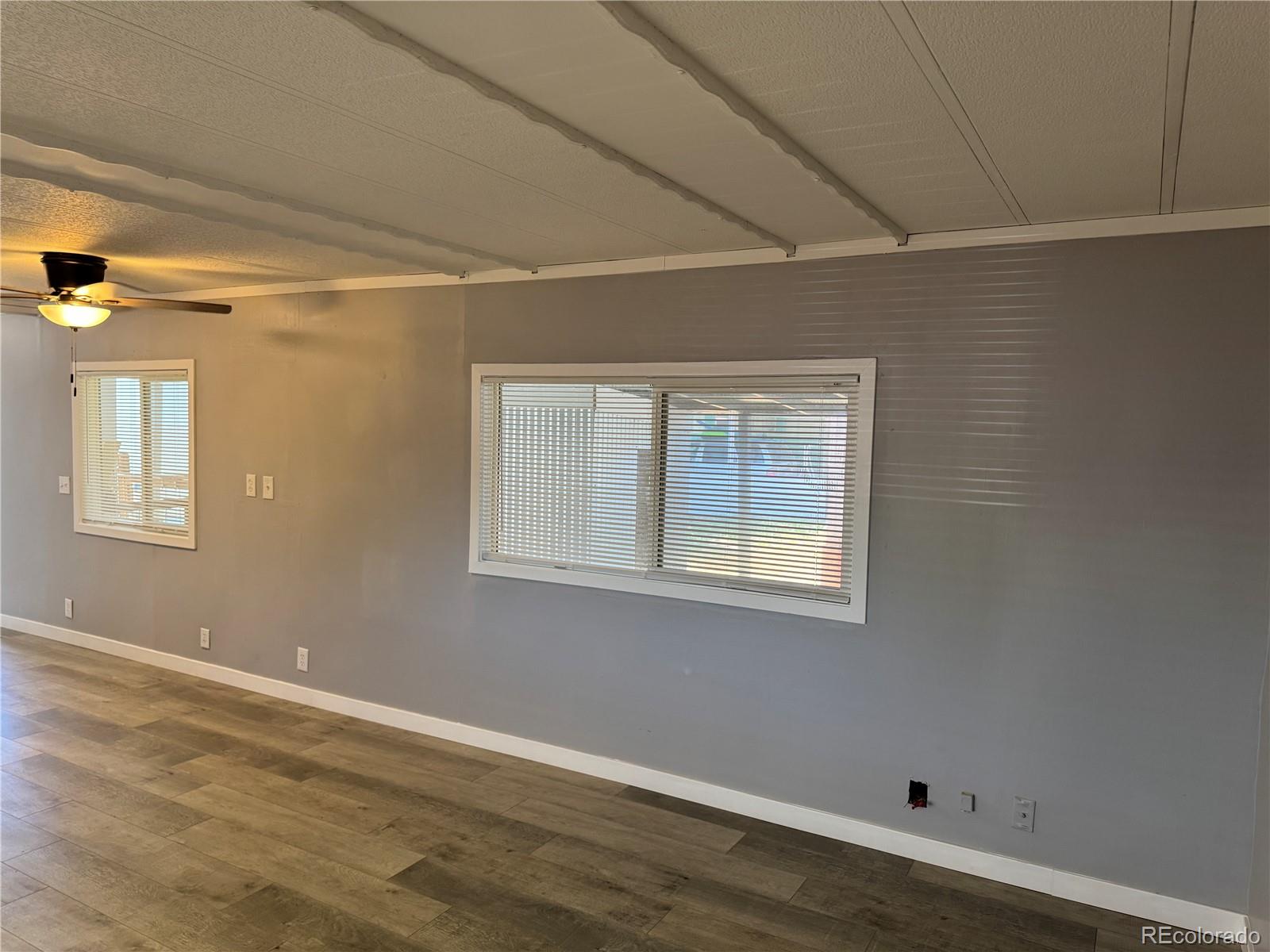 17190 Mt Vernon Road, Unit 176 Golden, CO 80401 - Photo 32 of 39 a view of an empty room with wooden floor and a window