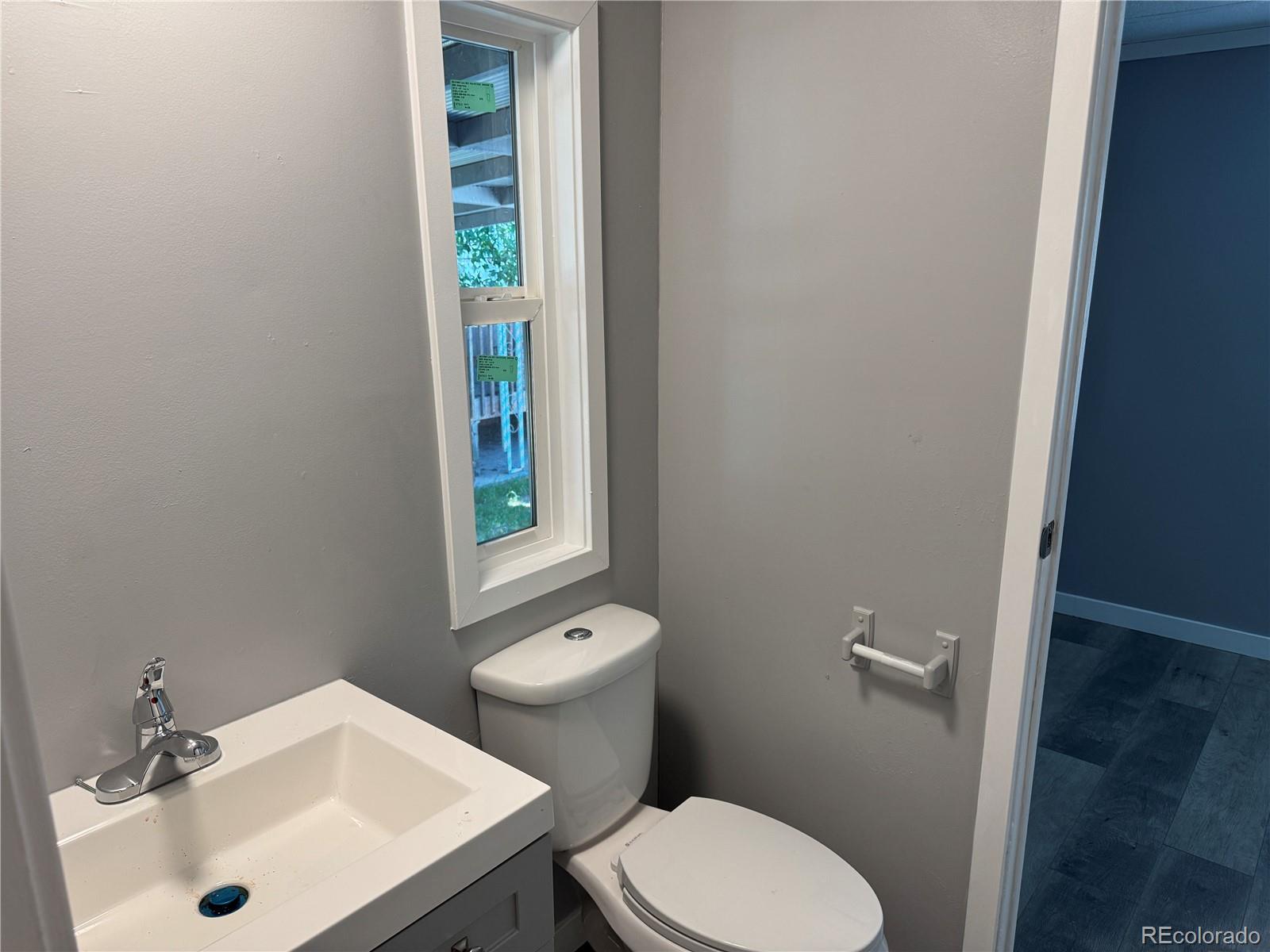 17190 Mt Vernon Road, Unit 176 Golden, CO 80401 - Photo 35 of 39 a white toilet sitting next to a bathroom sink