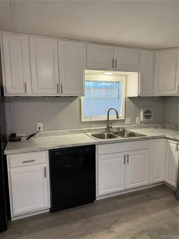 a kitchen with granite countertop a sink stove and cabinets