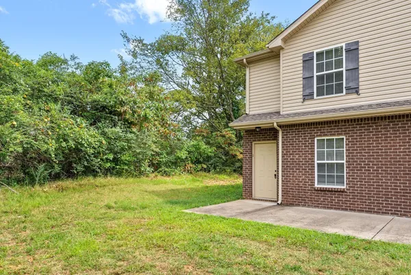 a view of a livingroom with wooden floor and a ceiling fan