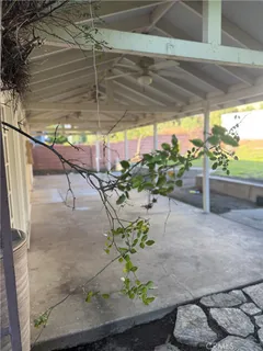 a patio with table and chairs and potted plants