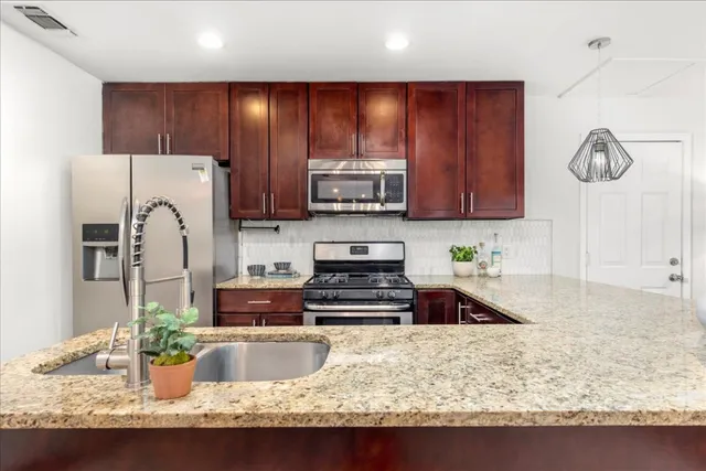 a kitchen with granite countertop wooden cabinets and a granite counter tops