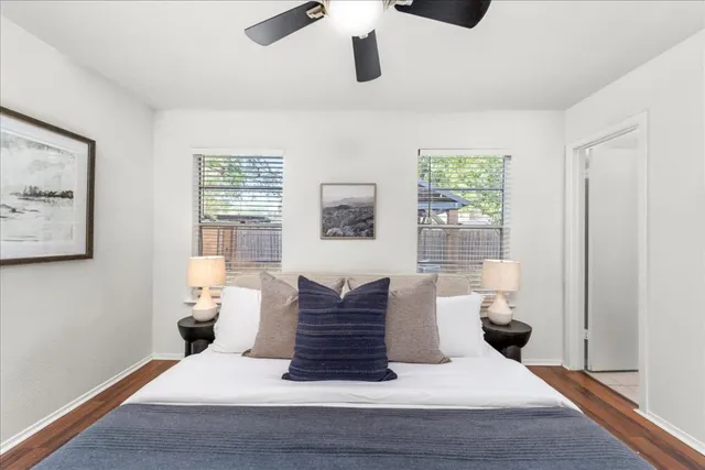 a bedroom with a large bed and a chandelier