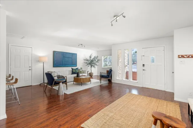 a living room with furniture and wooden floor