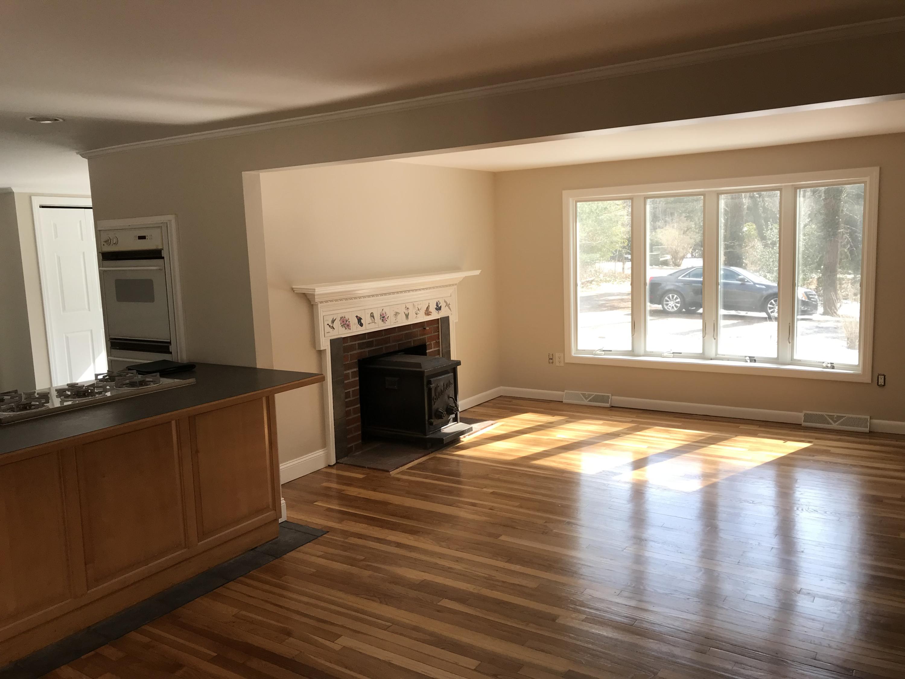 306 Old Mill Road Marstons Mills, MA 02648 - Photo 11 of 20 a view of empty room with wooden floor and fireplace