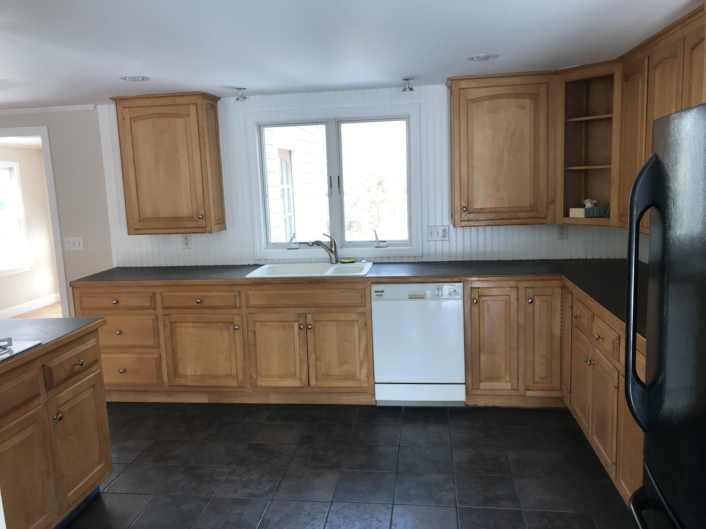 306 Old Mill Road Marstons Mills, MA 02648 - Photo 3 of 20 a kitchen with granite countertop white cabinets and stainless steel appliances