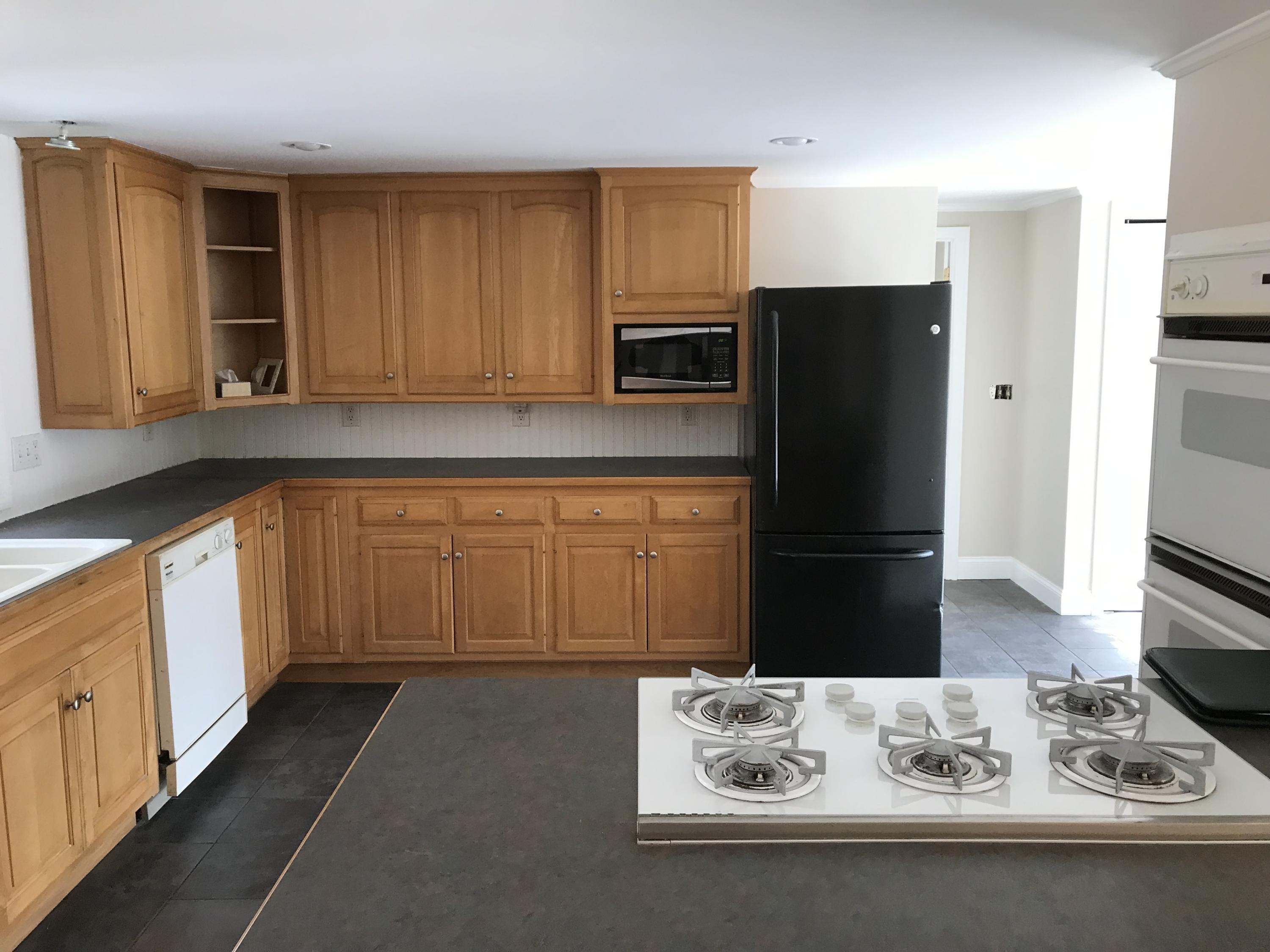 306 Old Mill Road Marstons Mills, MA 02648 - Photo 7 of 20 a kitchen with stainless steel appliances wooden cabinets and a refrigerator