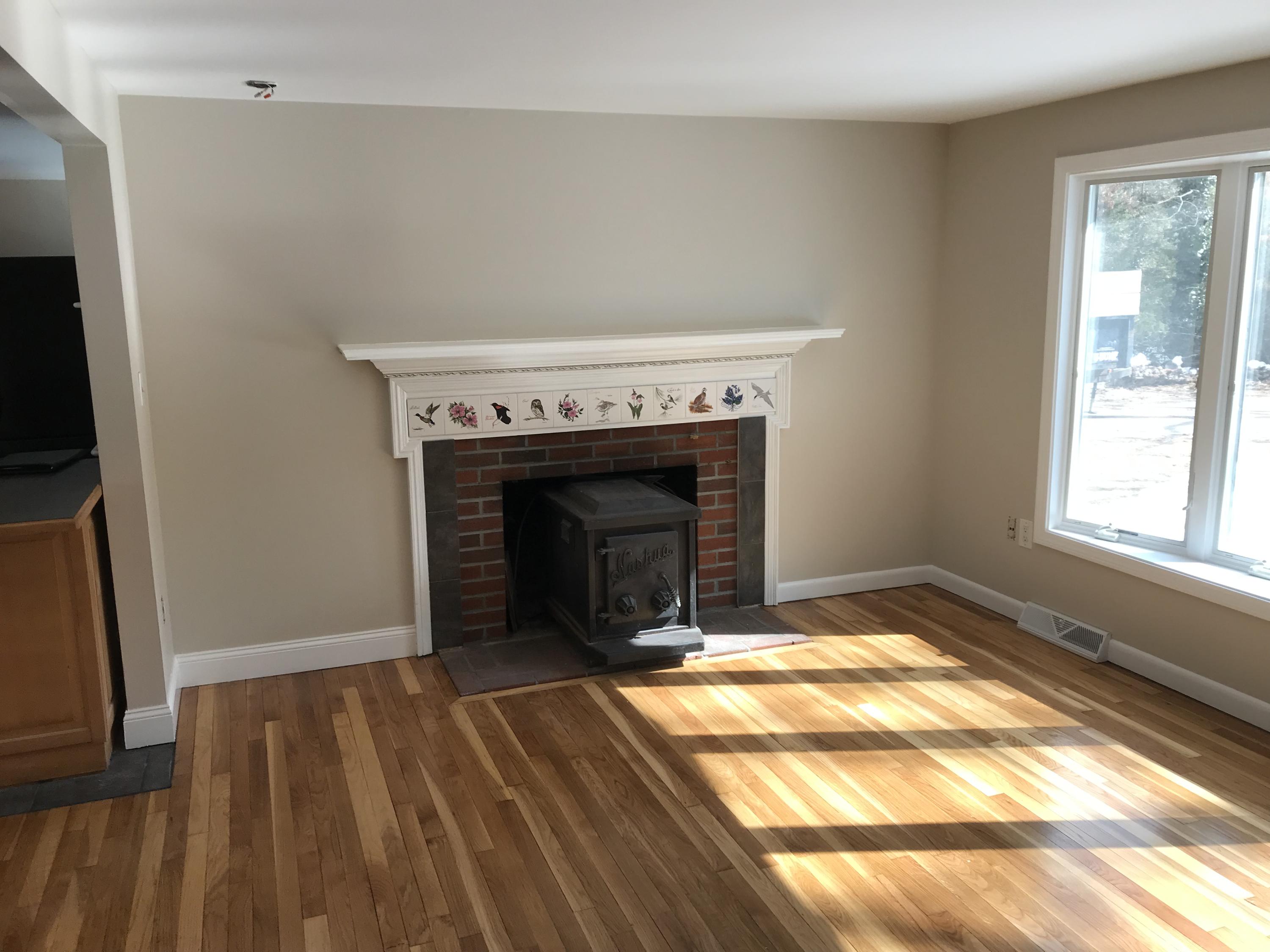 306 Old Mill Road Marstons Mills, MA 02648 - Photo 8 of 20 a view of an empty room with wooden floor fireplace and a window