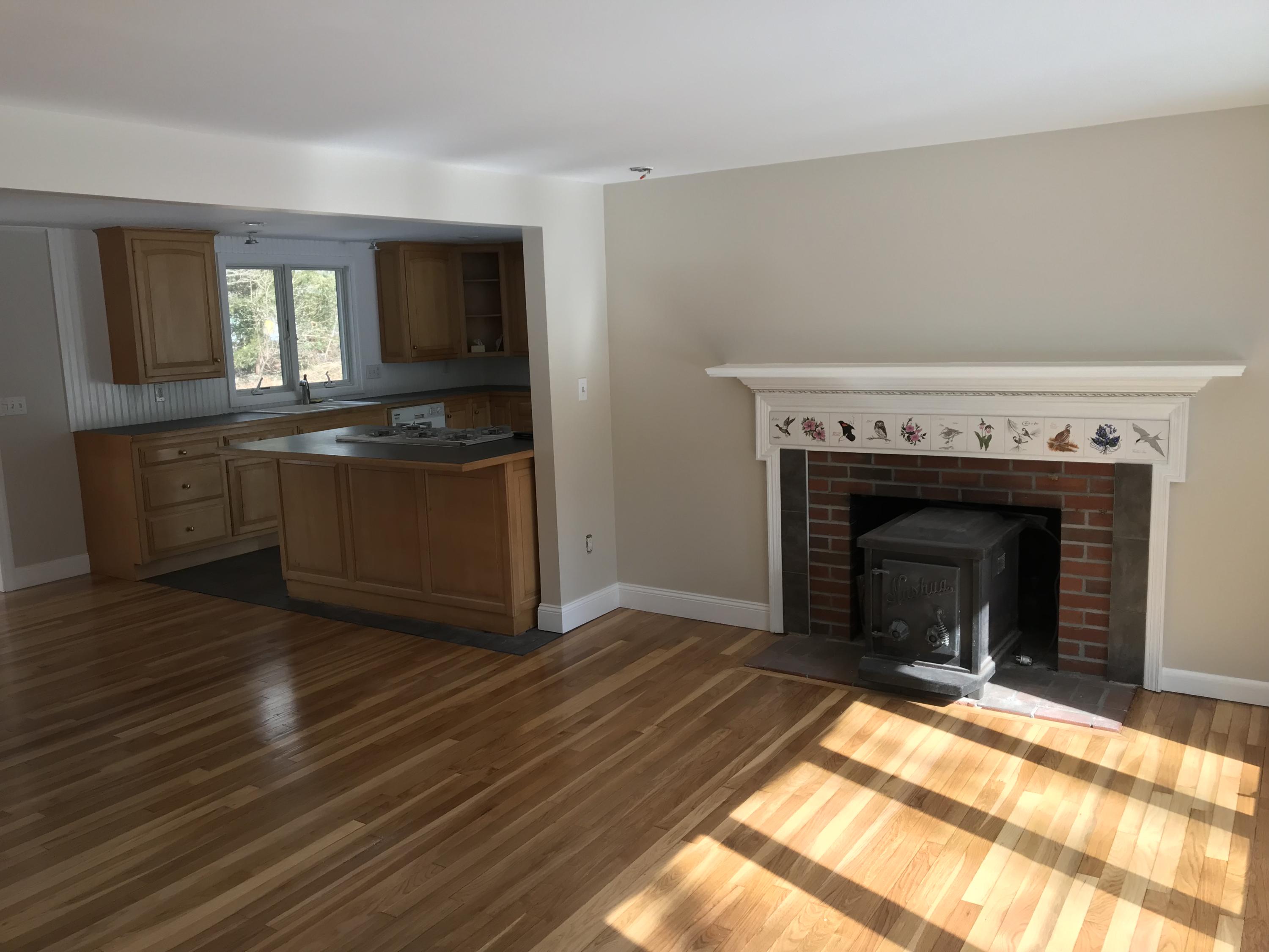 306 Old Mill Road Marstons Mills, MA 02648 - Photo 9 of 20 a view of empty room with wooden floor and fireplace