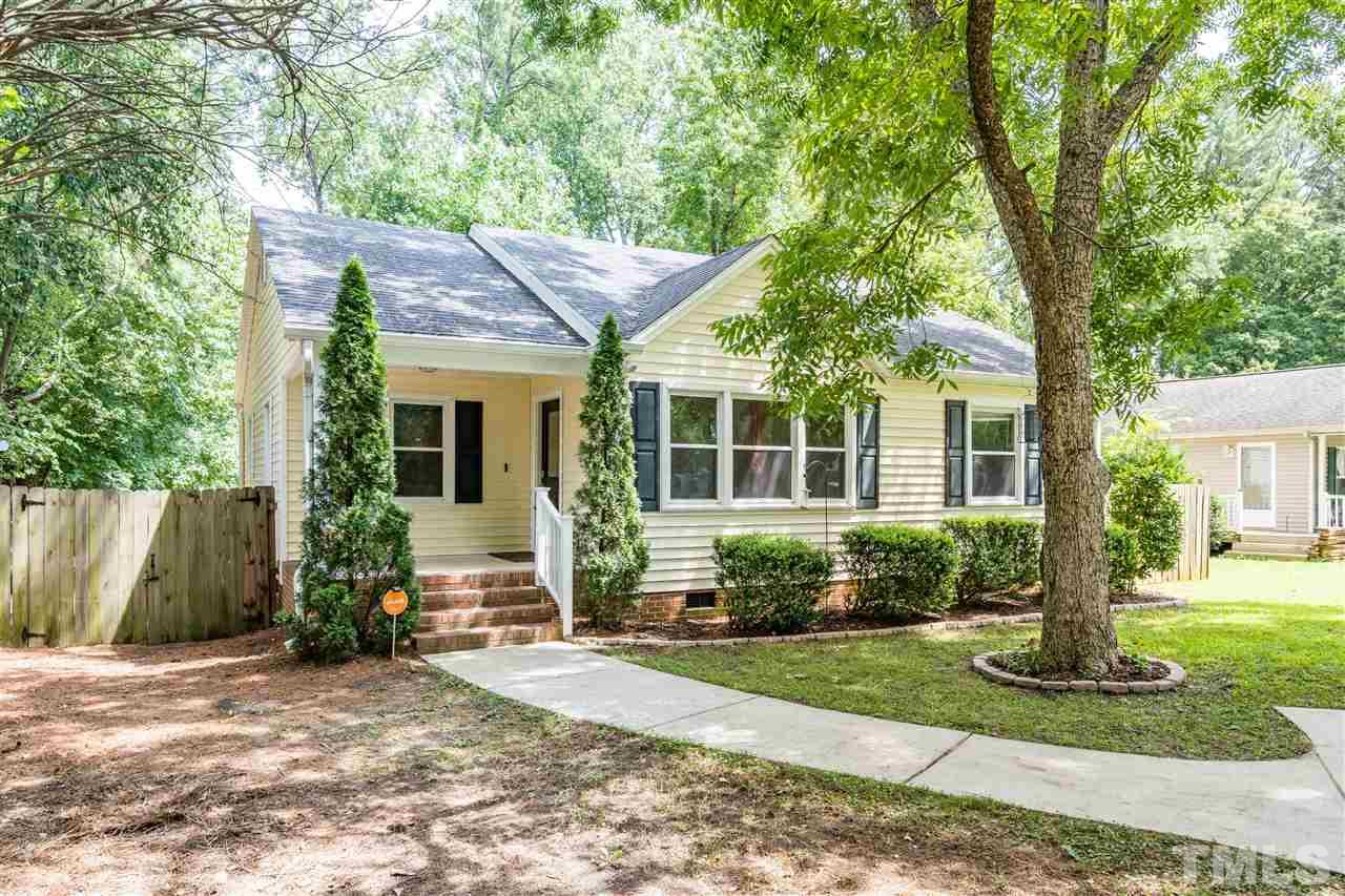 1234 Cross Link Road Raleigh, NC 27610 - Photo 1 of 26 a front view of a house with a yard and potted plants
