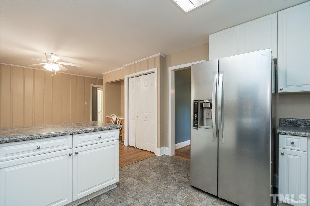 1234 Cross Link Road Raleigh, NC 27610 - Photo 12 of 26 a kitchen with a refrigerator and a sink