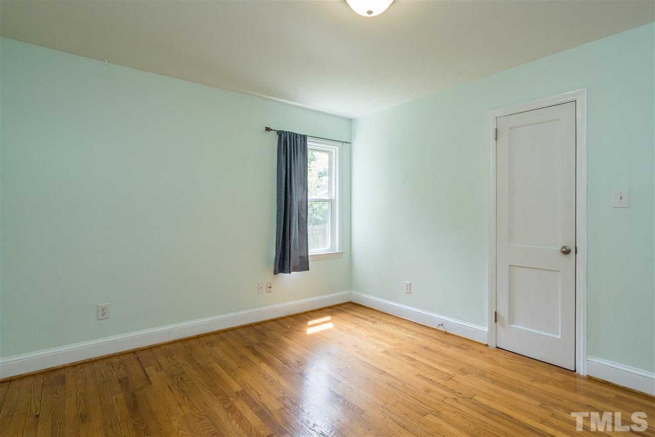 1234 Cross Link Road Raleigh, NC 27610 - Photo 20 of 26 an empty room with wooden floor and windows