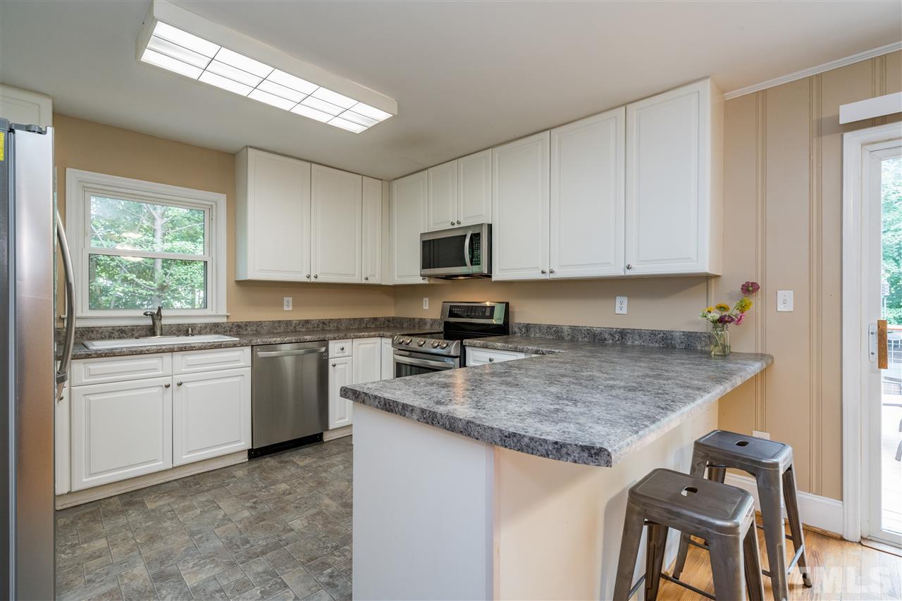1234 Cross Link Road Raleigh, NC 27610 - Photo 10 of 26 a kitchen with a sink stove and microwave