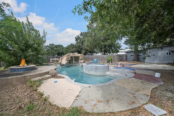 swimming pool view with a seating space