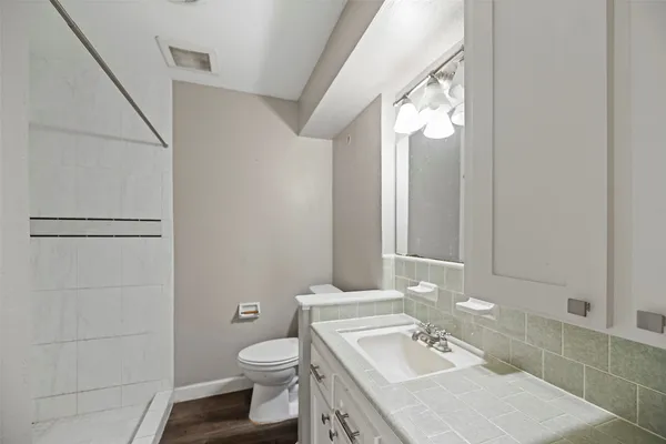 a bathroom with a sink toilet and shower