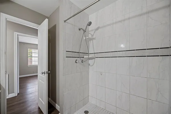 a bathroom with a shower and a shower