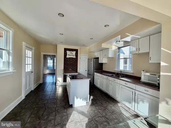 a kitchen with granite countertop lots of counter top space and stainless steel appliances