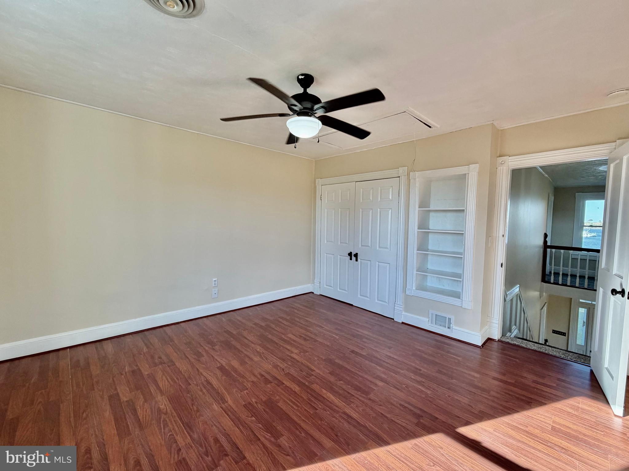 48600 Deep Cove Lane Ridge, MD 20680 - Photo 19 of 46 an empty room with wooden floor a ceiling fan and closet
