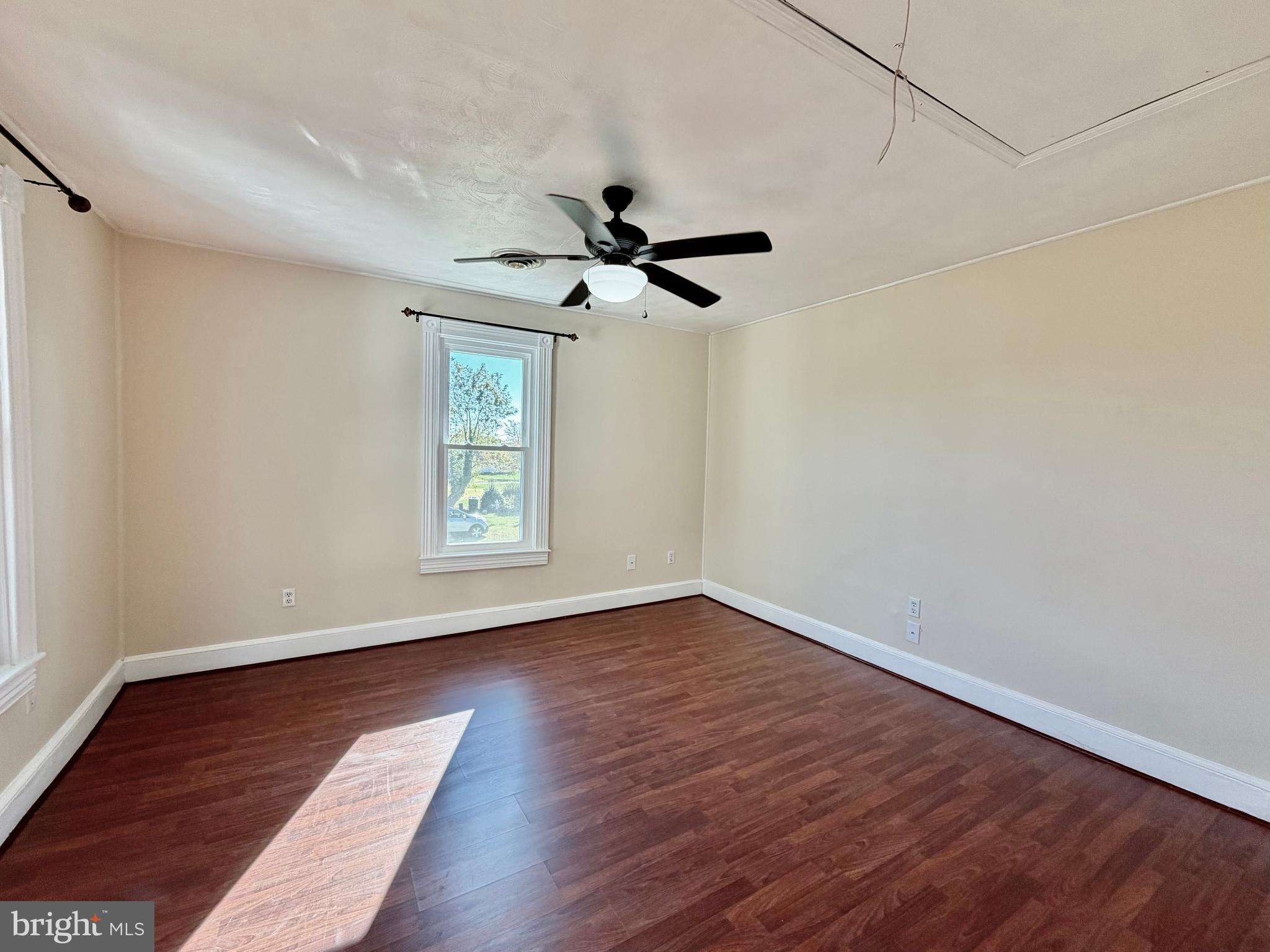 48600 Deep Cove Lane Ridge, MD 20680 - Photo 20 of 46 a view of an empty room with wooden floor and a window