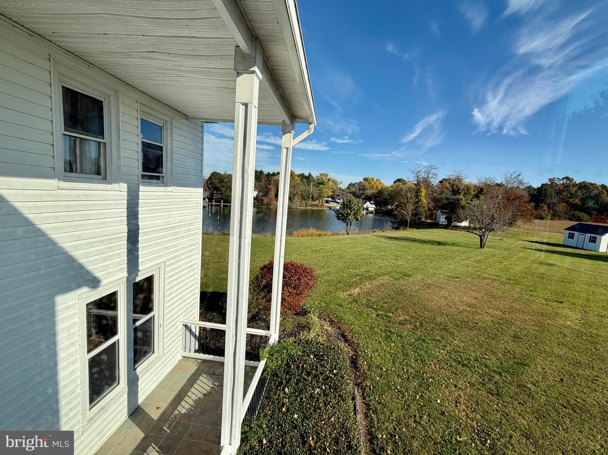 48600 Deep Cove Lane Ridge, MD 20680 - Photo 21 of 46 a backyard of a house with table and chairs