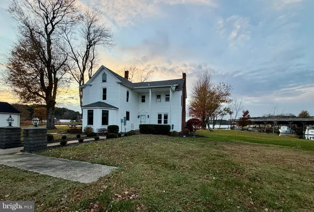 a view of a house with a yard in the background