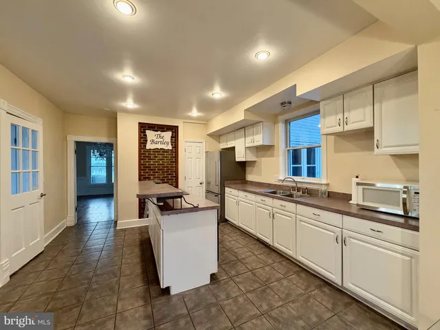 a kitchen with counter top space sink and center