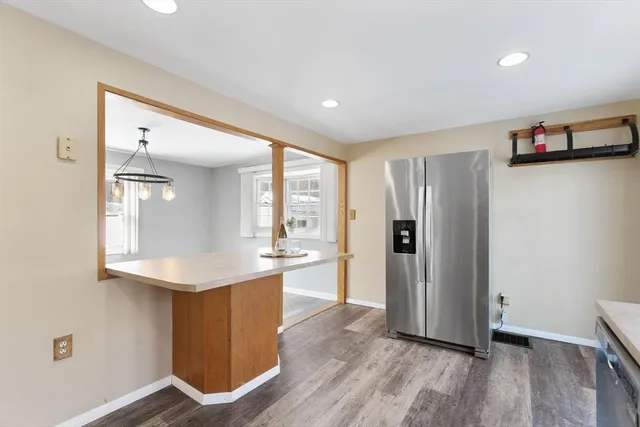 a kitchen with stainless steel appliances granite countertop a refrigerator and a sink