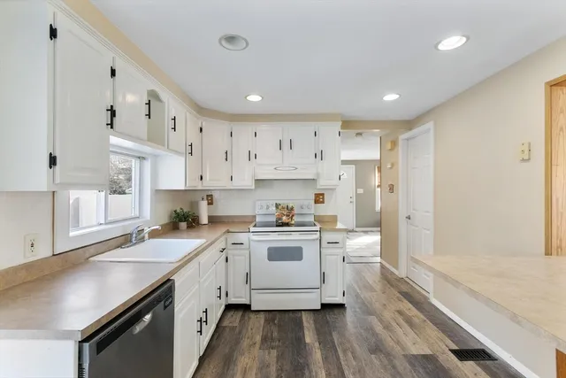 a kitchen with a stove a sink and a refrigerator